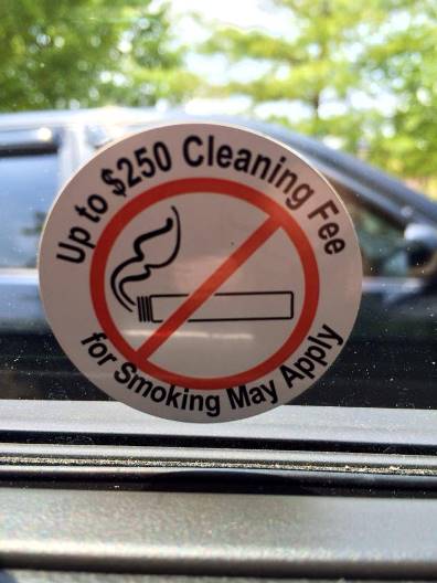 Avis sign about smokefree cars and cleaning fee for smoking