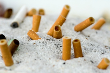 Cigarette butts in sand on beach
