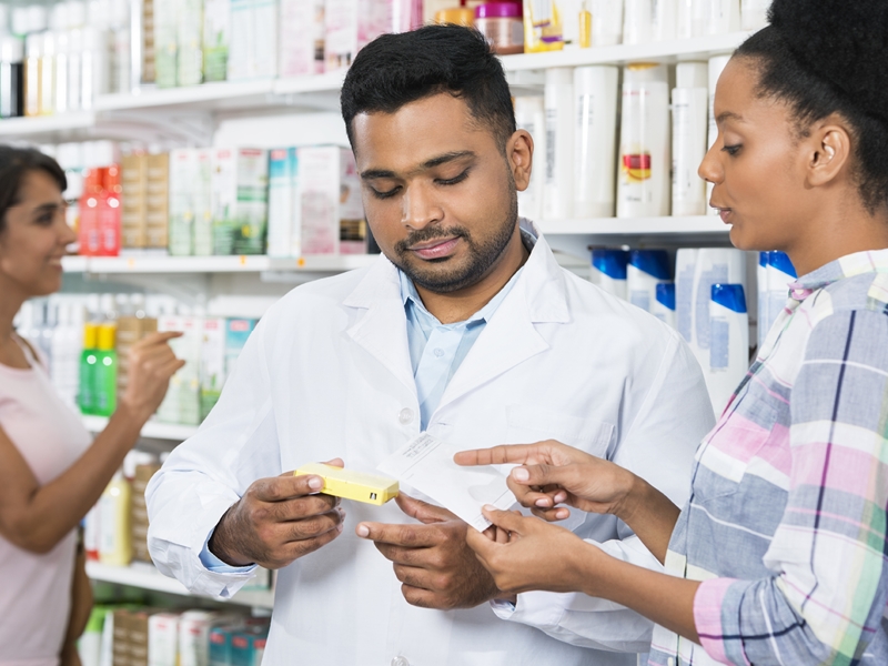 Pharmacists assisting customer