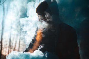 man in cloud of vapor or smoke
