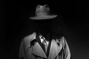 faceless noir man in fedora and trenchcoat