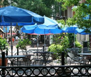 sidewalk restaurant dining patio with umbrellas